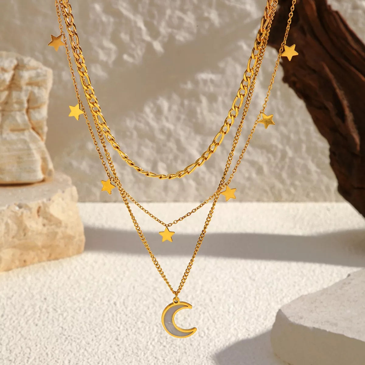 18K gold-plated moon three-layered necklace with delicate chains and celestial pendant, showcasing elegant jewelry design.