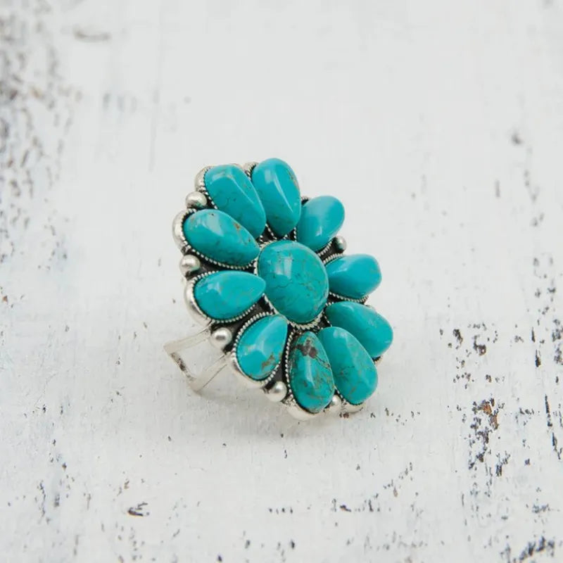 Artificial turquoise alloy flower ring with intricate floral design, featuring vibrant turquoise accents and a polished silver-tone finish.