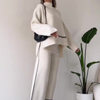 Women’s solid color casual two-piece set by FitiqueFit with loose top and bootcut pants, perfect for everyday comfortable wear.