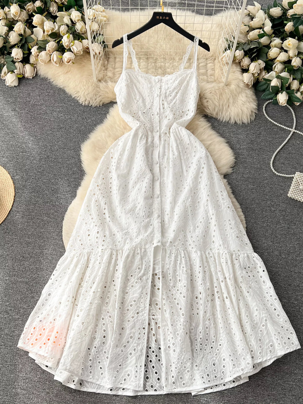 Eyelet embroidered tiered camisole dress with boho style, perfect for summer, featuring a flowing midi design from Trendsi.