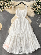 Eyelet embroidered tiered camisole dress with boho style, perfect for summer, featuring a flowing midi design from Trendsi.