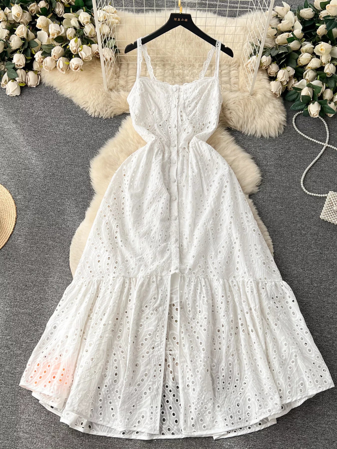 Eyelet embroidered tiered camisole dress with boho style, perfect for summer, featuring a flowing midi design from Trendsi.