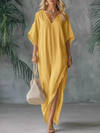 Plus size full-length V-neck maxi dress with side slits from Shopimist, featuring a flowy silhouette and comfortable fit.