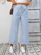 Women's striped wide-leg drawstring pants with pockets from Trendsi, shown in a relaxed fit with bold horizontal stripes.