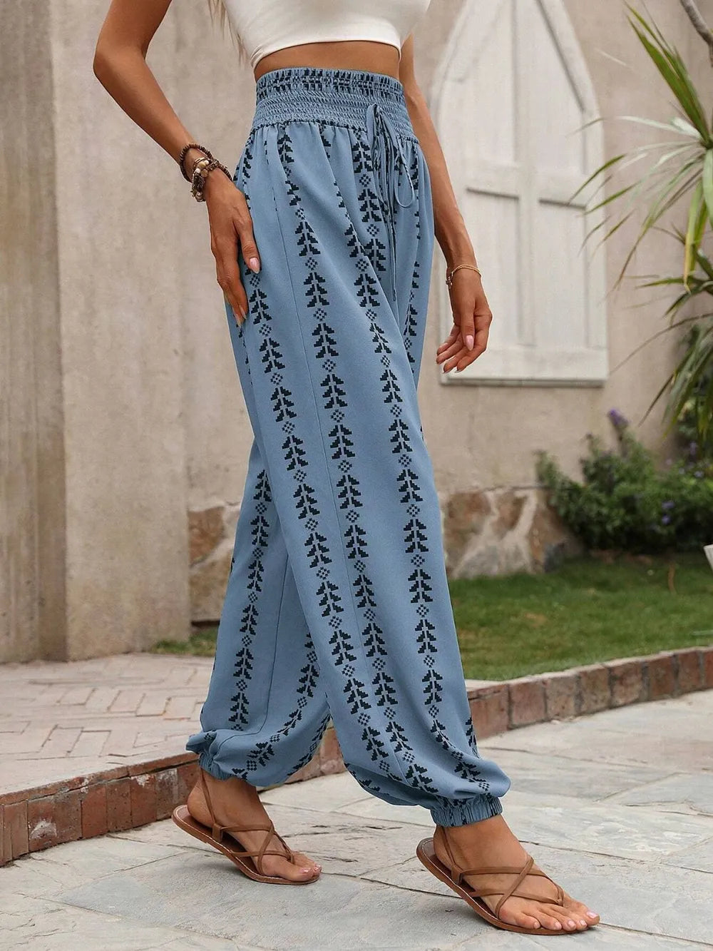 Plush Fashion Hub printed high waist pants with a stylish design, shown in a close-up view highlighting fabric and pattern.