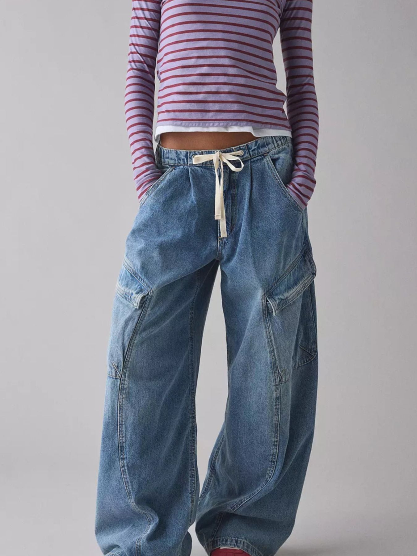 Women's relaxed fit denim cargo jeans with drawstring waist, utility style, blue denim, casual and comfortable fit.