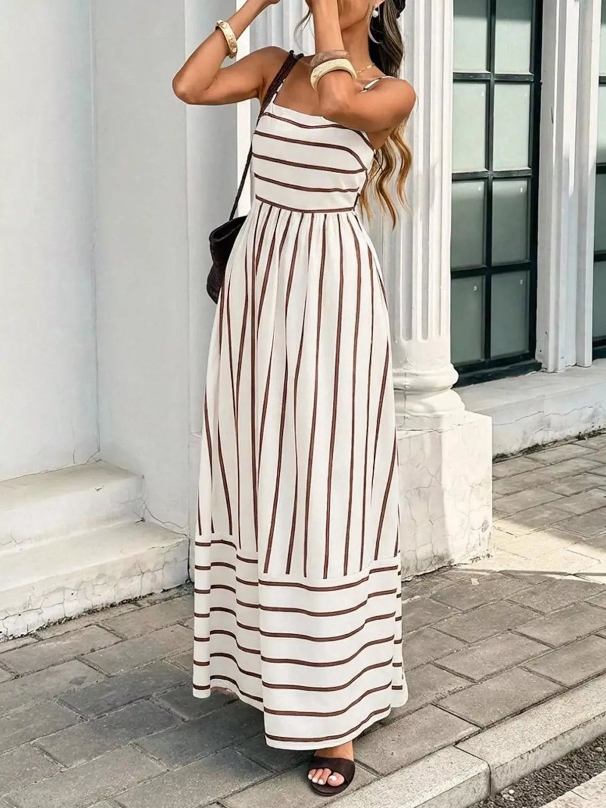 Plush Fashion Hub striped cutout back maxi dress with bold pattern, sleeveless design, and flowing fabric for elegant summer style.