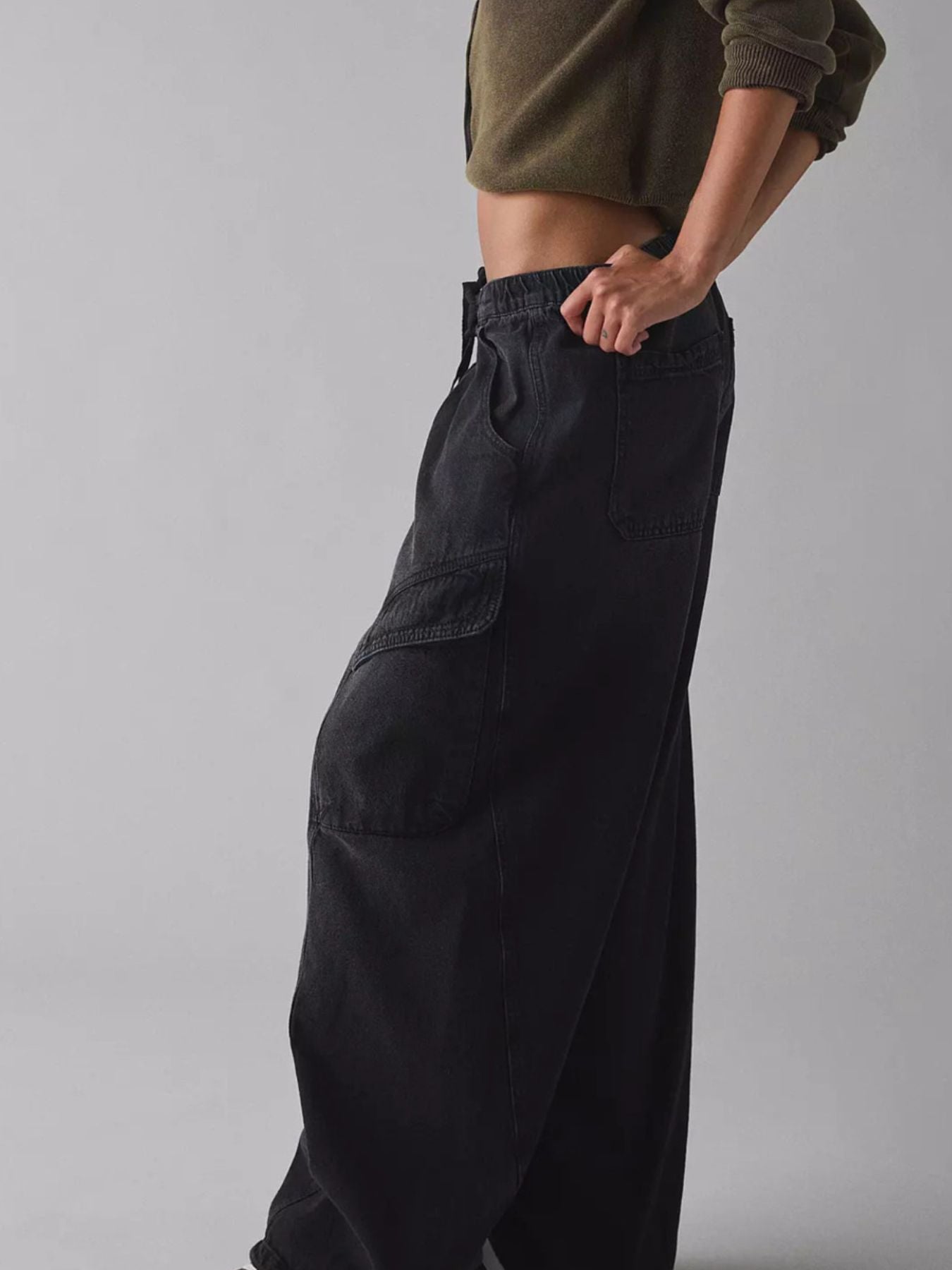 Women’s relaxed fit cargo jeans with drawstring waist, utility denim pants by Trendsi featuring multiple pockets and casual style.