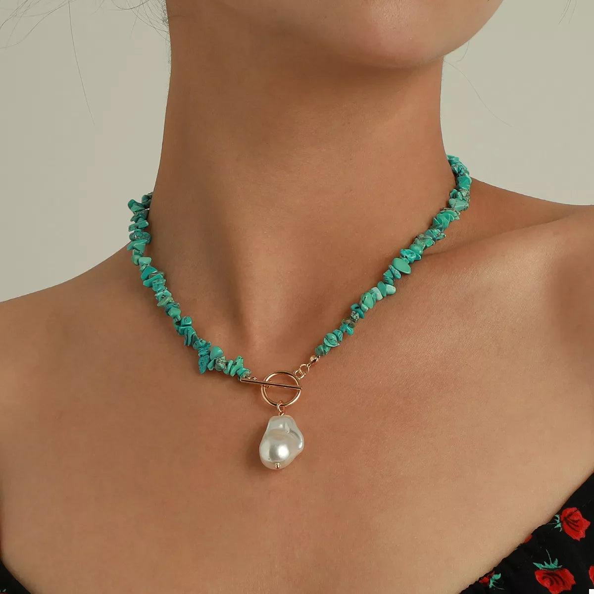 Turquoise irregular pearl necklace from Plush Fashion Hub featuring unique-shaped pearls on a stylish jewelry piece.