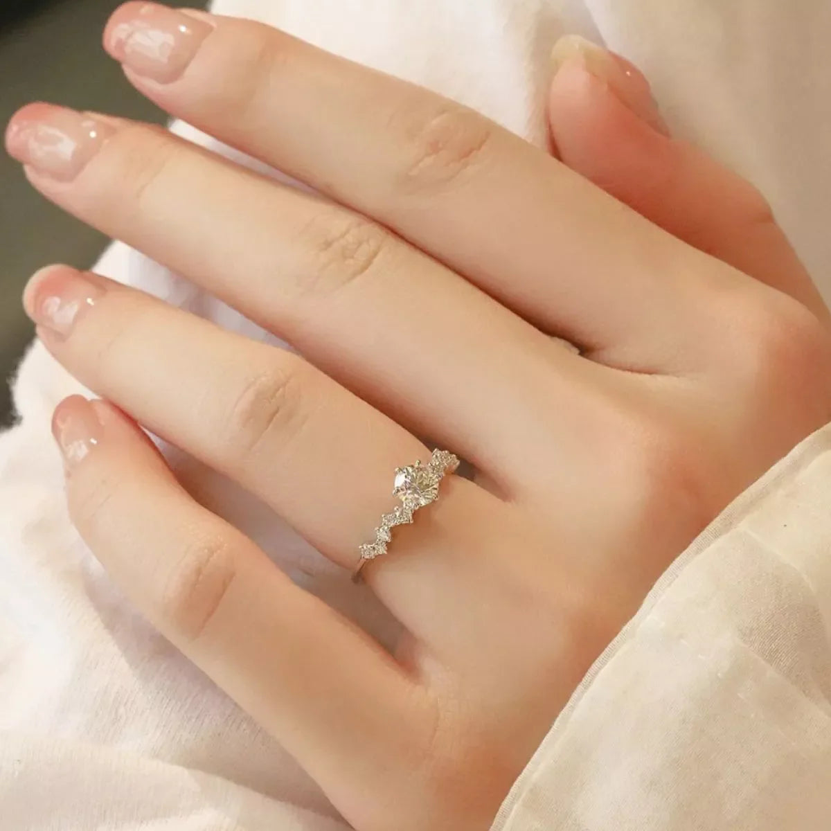 Sterling silver 2 carat moissanite ring with intricate band design, showcasing sparkling gemstone and elegant craftsmanship.