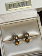 Tiger Eye stud earrings featuring polished, oval-shaped gemstones set in silver-tone metal, stylish and versatile jewelry accessory