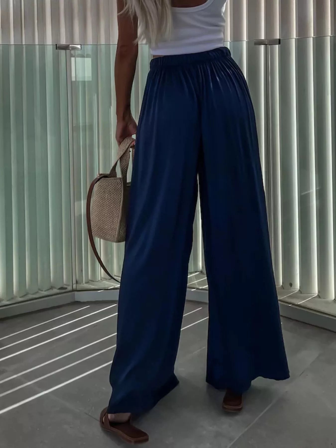 Wide-leg flowy pants from Trendsi, featuring a relaxed fit and lightweight fabric, shown in a natural drape and movement.