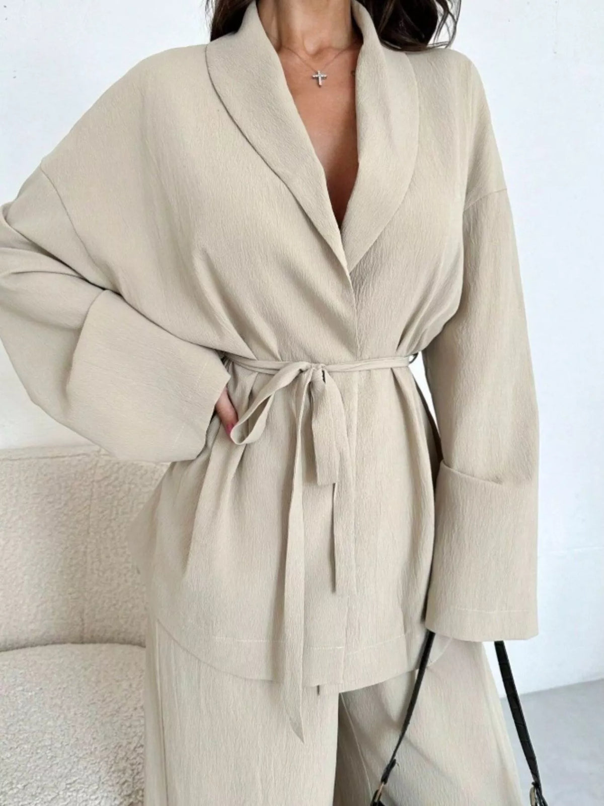 Textured tie waist top and wide-leg pants set for women, featuring a stylish, coordinated look with a comfortable fit.