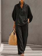 Plus size women's two-piece dress set with button details and 3/4 sleeves, featuring a stylish top and matching pants.
