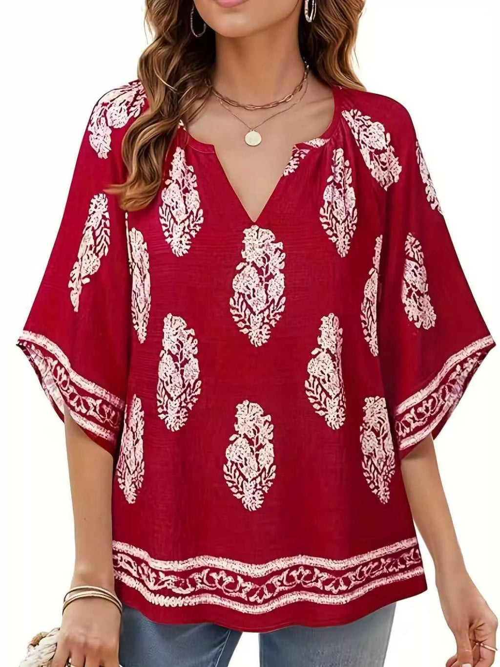 Printed notched 3/4 sleeve blouse from Trendsi, featuring a stylish design with a flattering fit and elegant details.