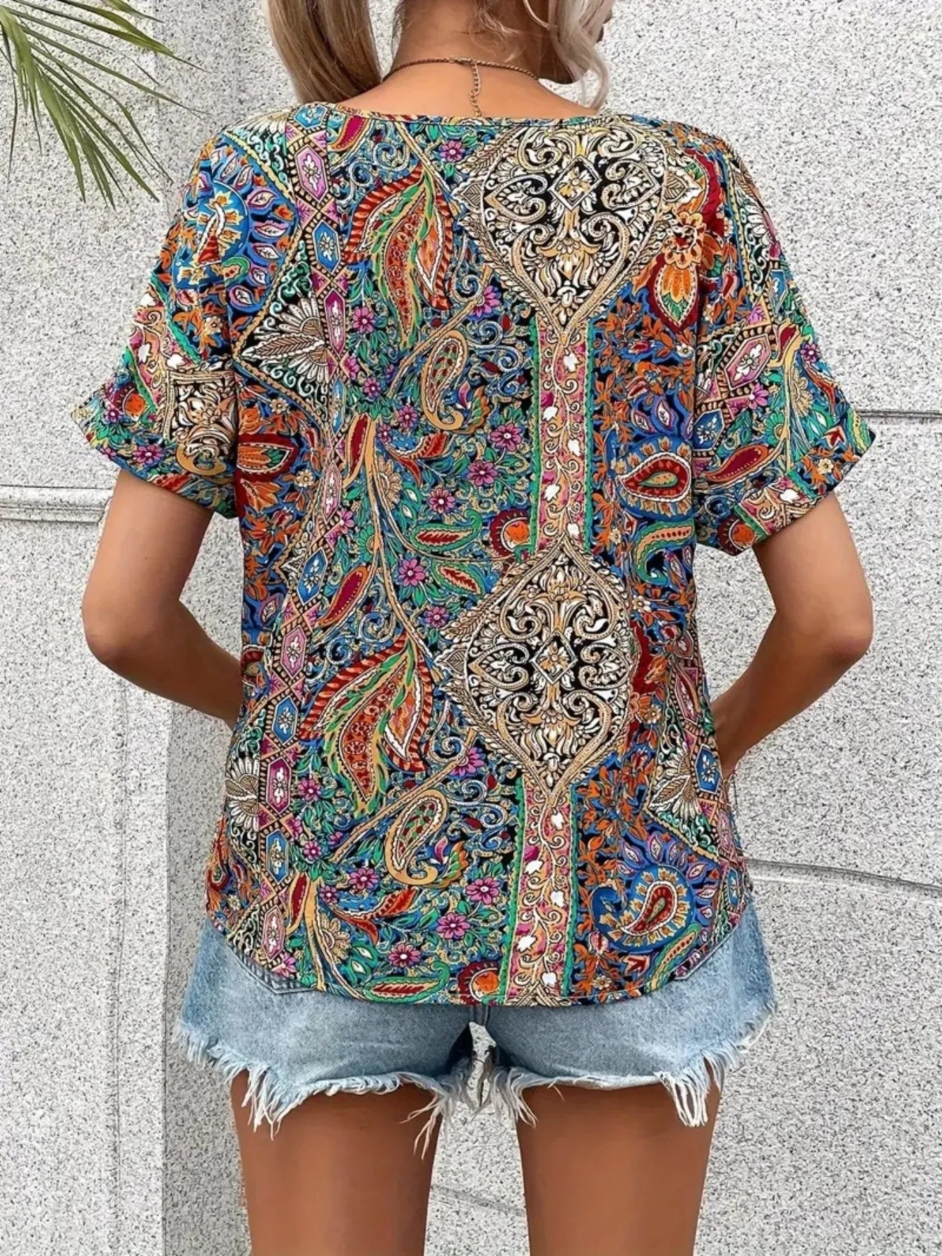 Bohemian paisley V-neck short sleeve T-shirt by Plush Fashion Hub featuring colorful paisley pattern and relaxed fit.