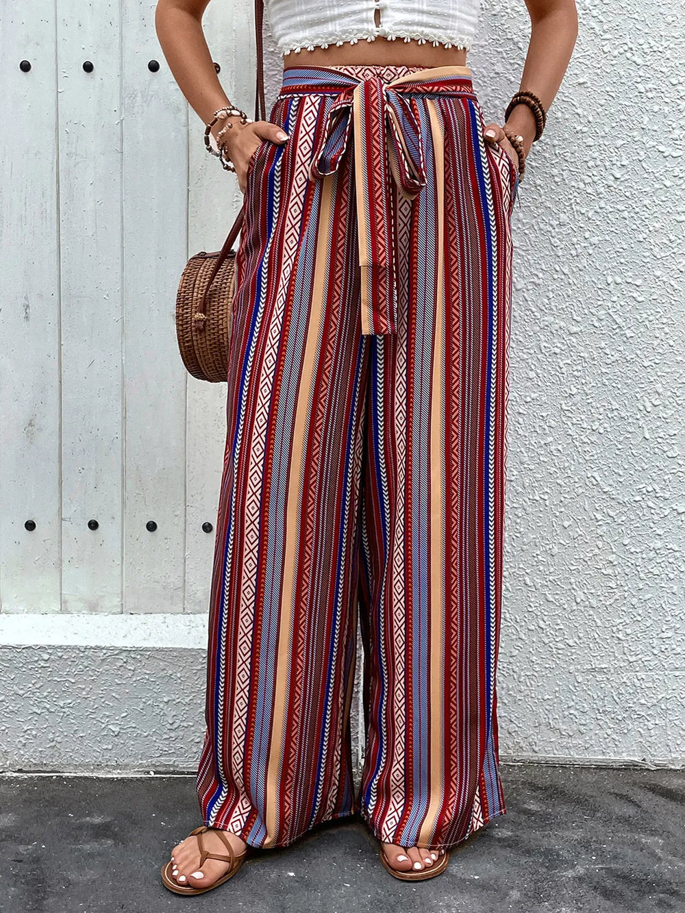 Plush Fashion Hub geometric tied wide-leg pants with bold pattern, high waist, and flowing silhouette, displayed on a hanger.