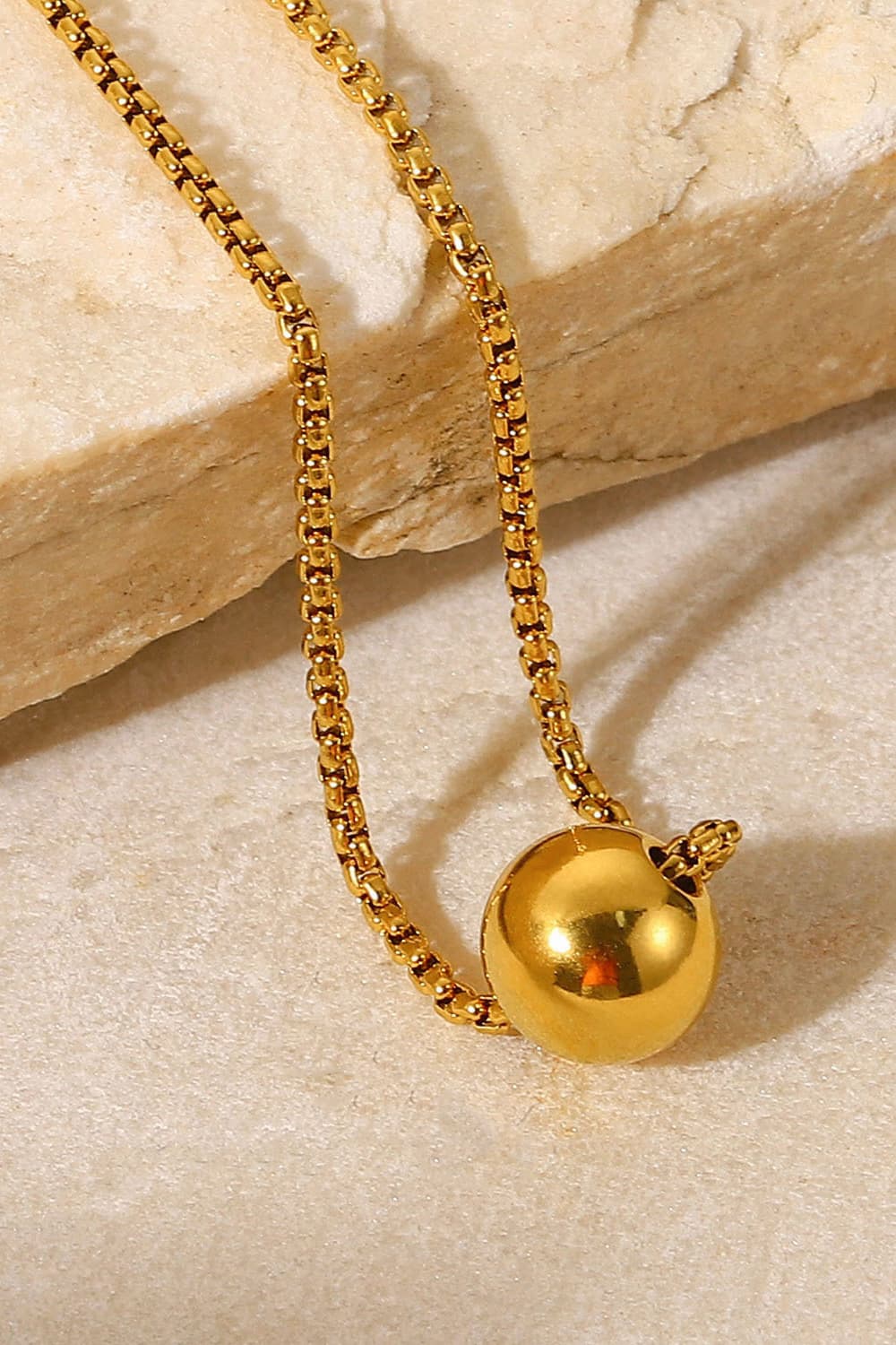 18K gold-plated round pendant necklace with a sleek, polished finish, featuring a delicate chain and elegant design.