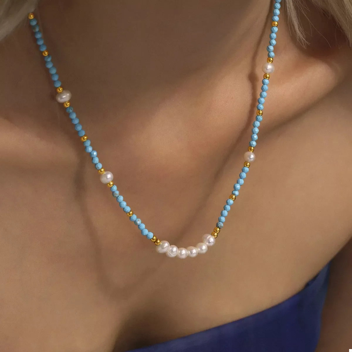 Turquoise pearl beaded necklace from Plush Fashion Hub featuring a string of vibrant turquoise and white pearls.