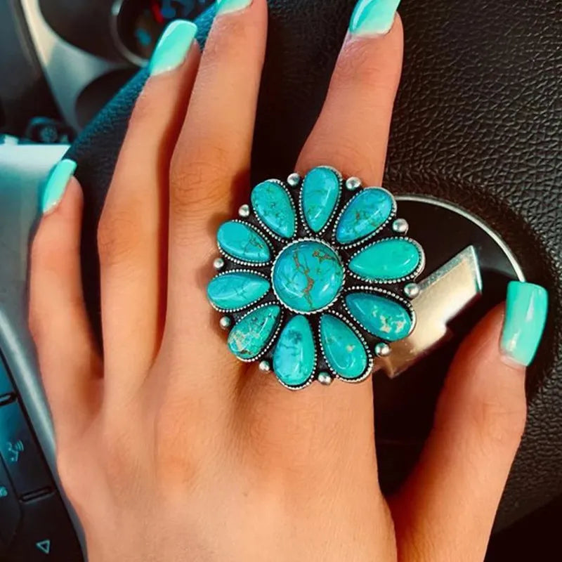 Artificial turquoise alloy flower ring with intricate floral design, featuring vibrant turquoise stones and silver-tone alloy band.