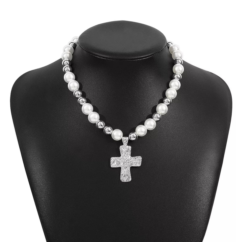 Pearl and cross pendant necklace from Plush Fashion Hub, featuring a white pearl and silver cross charm on a delicate chain.