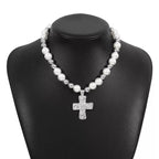 Pearl and cross pendant necklace from Plush Fashion Hub, featuring a white pearl and silver cross charm on a delicate chain.