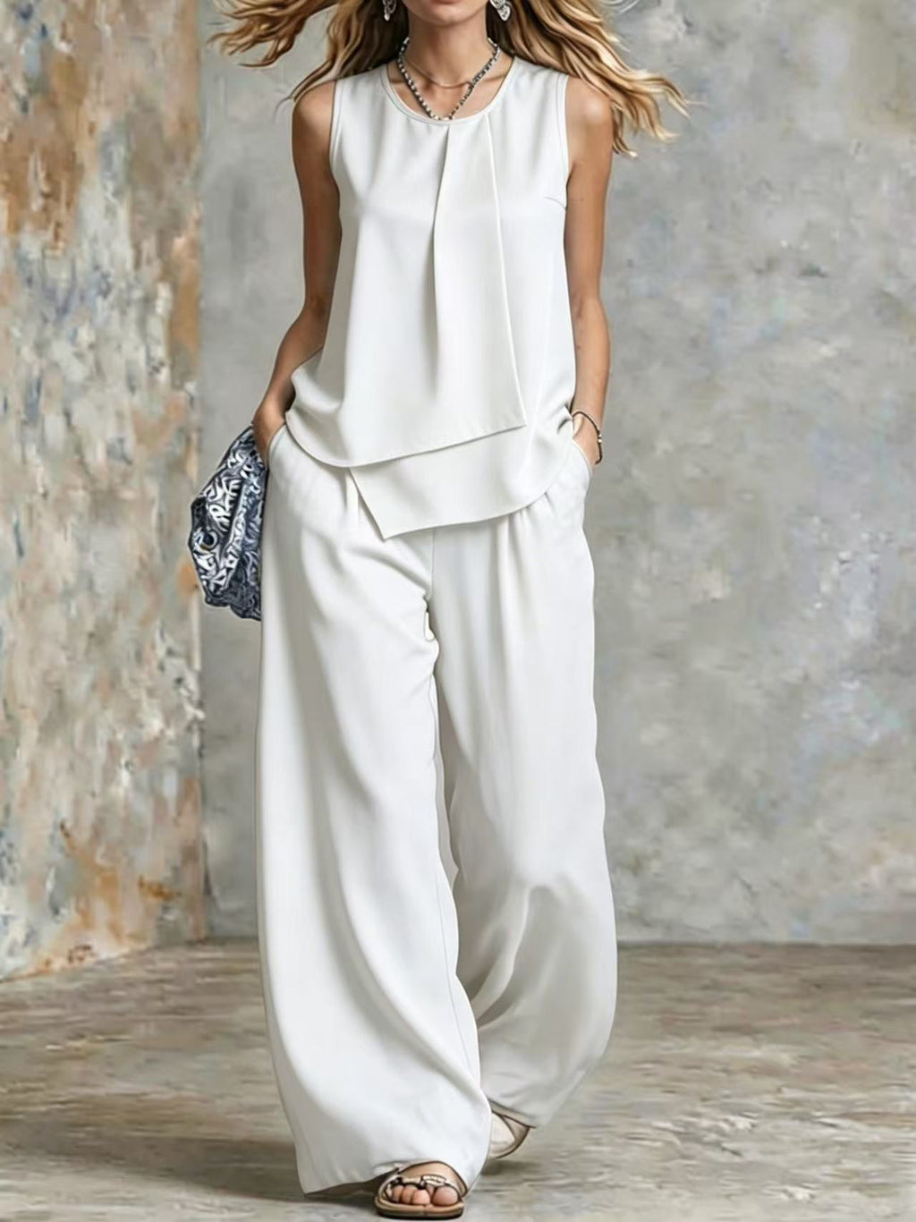 Women's sleeveless two-piece set with solid color wide-leg pants and matching top from Plush Fashion Hub, shown on a model.