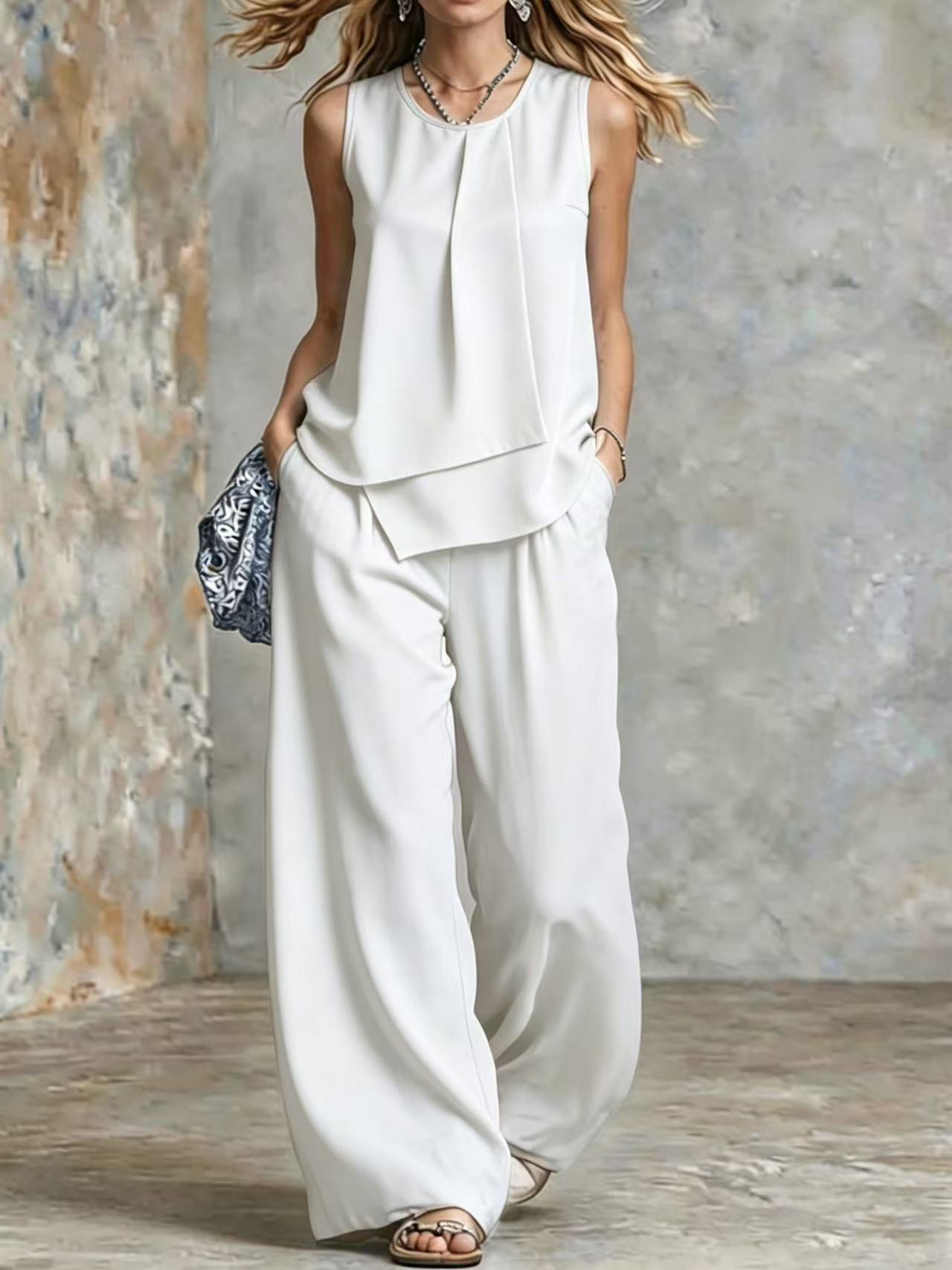 Women's sleeveless two-piece set with solid color wide-leg pants and matching top from Plush Fashion Hub, shown on a model.