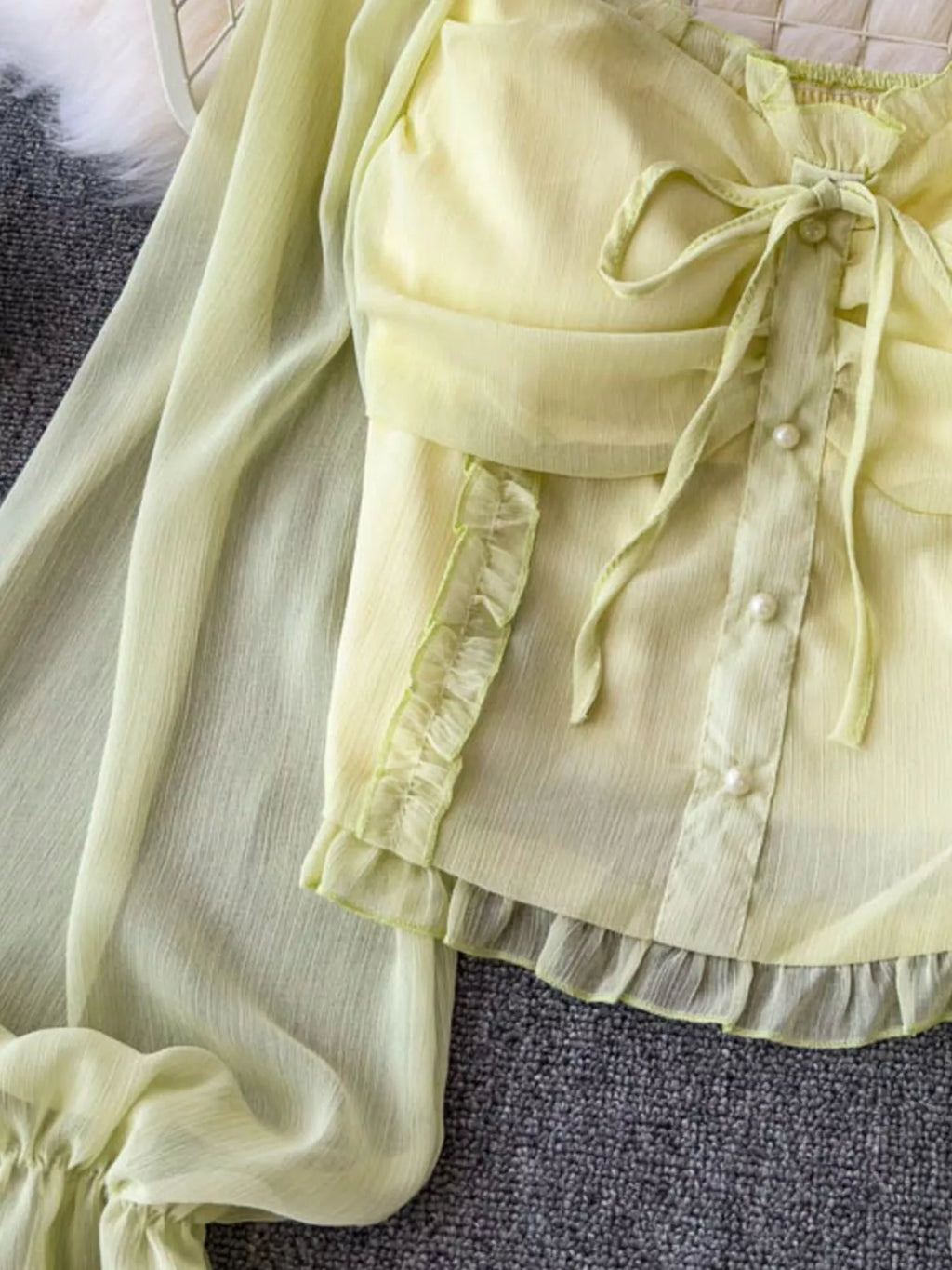 Women's elegant frill flounce sleeve smocked blouse made of lightweight polyester, featuring a stylish dress design with intricate detailing.