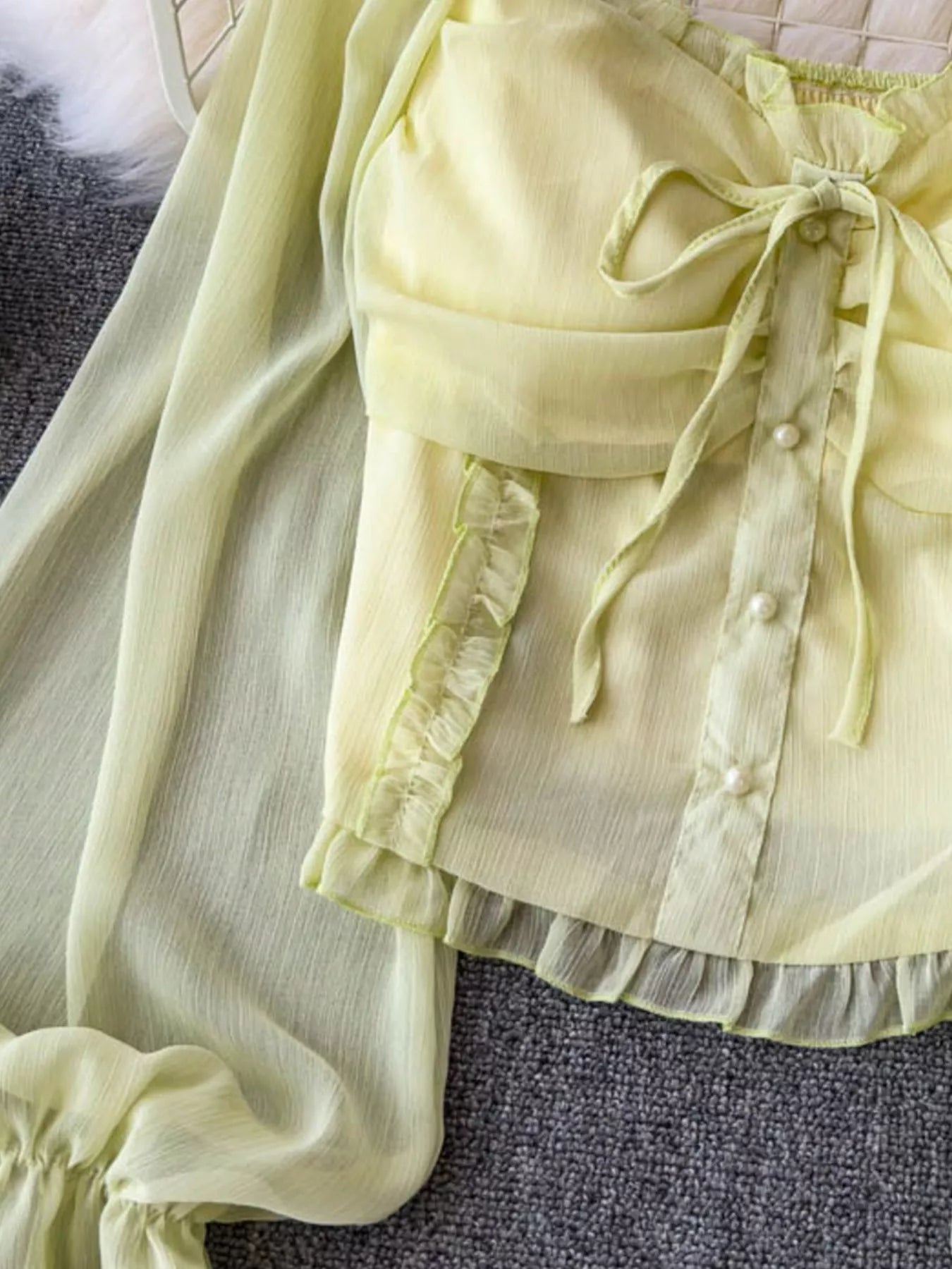 Women's elegant frill flounce sleeve smocked blouse made of lightweight polyester, featuring a stylish dress design with intricate detailing.
