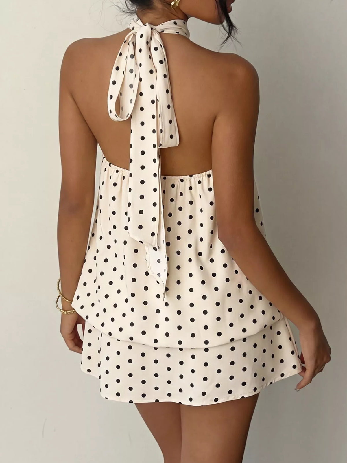 Polka dot halter neck mini dress from Plush Fashion Hub, featuring a stylish design with a fitted bodice and flared skirt.