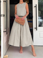 Women's striped sleeveless top and midi skirt two-piece set by Trendsi, featuring a stylish, coordinated outfit with bold stripe patterns.