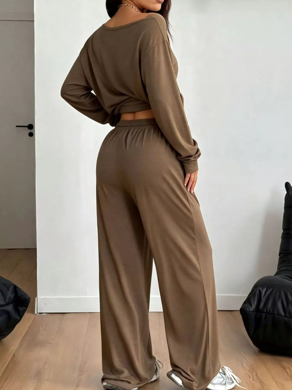 Plus size loose fit one-shoulder T-shirt and pants set by Trendsi, featuring relaxed, comfortable fabric in a stylish casual look.