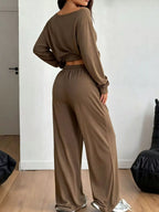 Plus size loose fit one-shoulder T-shirt and pants set by Trendsi, featuring relaxed, comfortable fabric in a stylish casual look.