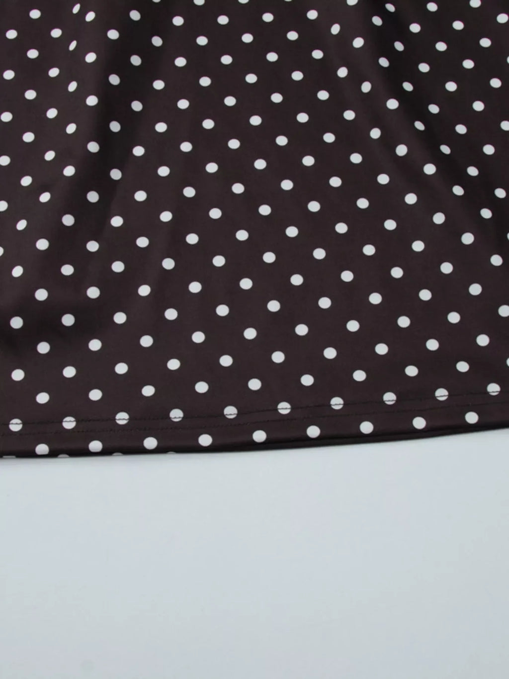 Polka dot cut-out front mini dress by Shopimist showing a stylish black and white spotted design with a cut-out detail at the front.