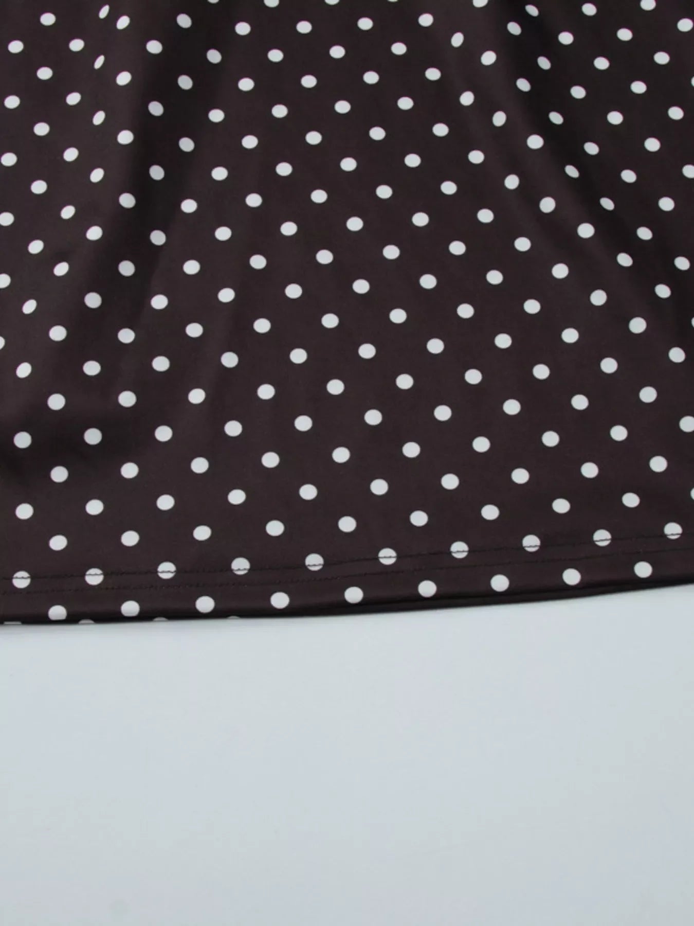 Polka dot cut-out front mini dress by Shopimist showing a stylish black and white spotted design with a cut-out detail at the front.
