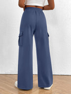 Women's high-waisted casual cargo pants with drawstring from Trendsi, lightweight utility pants featuring multiple pockets and relaxed fit.