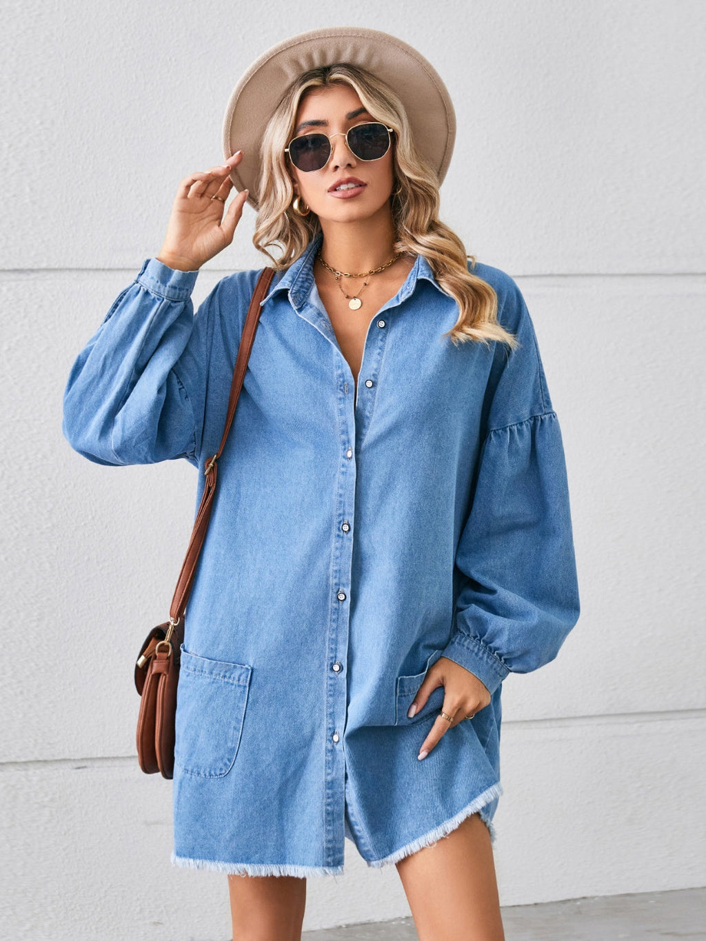 VYSN denim dress with button-up front, pocket details, and raw hem, showcasing casual and stylish clothing design.