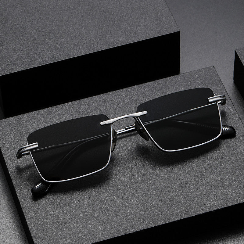 Pure titanium polarized sunglasses with retro British style, lightweight eye wear featuring dark tinted lenses and sleek frame design.