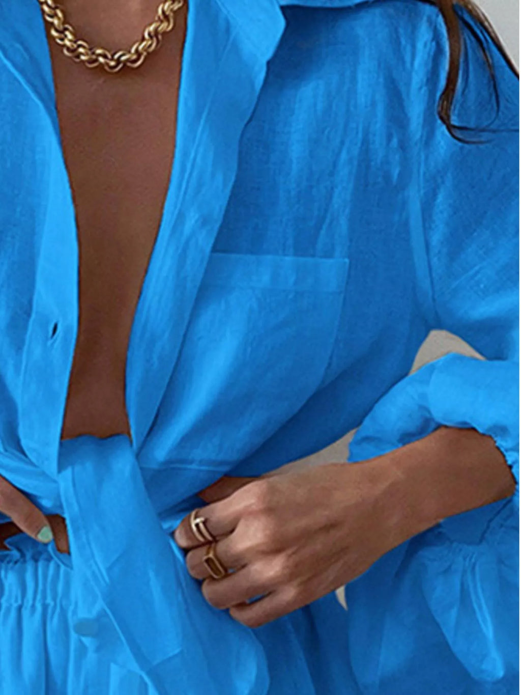 Women's button-up long sleeve shirt and shorts two-piece lounge set by Trendsi, featuring comfortable fabric and casual style.