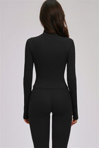 Fitglutes activewear Kinetic Zip Jacket, cross back sports bra, and leggings 3-piece workout set on a model.