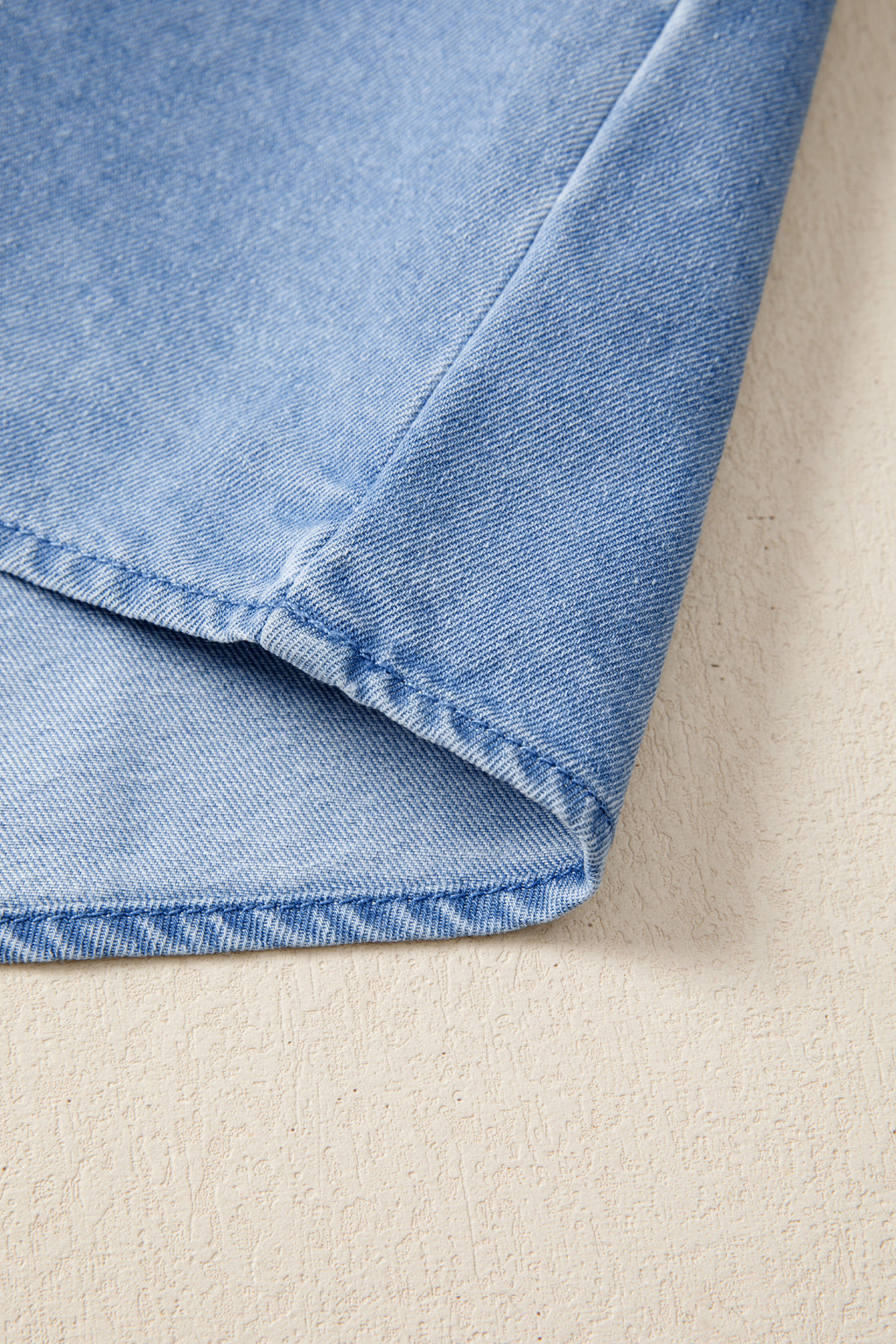Women's distressed denim top with frilled collar and flutter sleeves, stylish casual blouse from Trendsi.