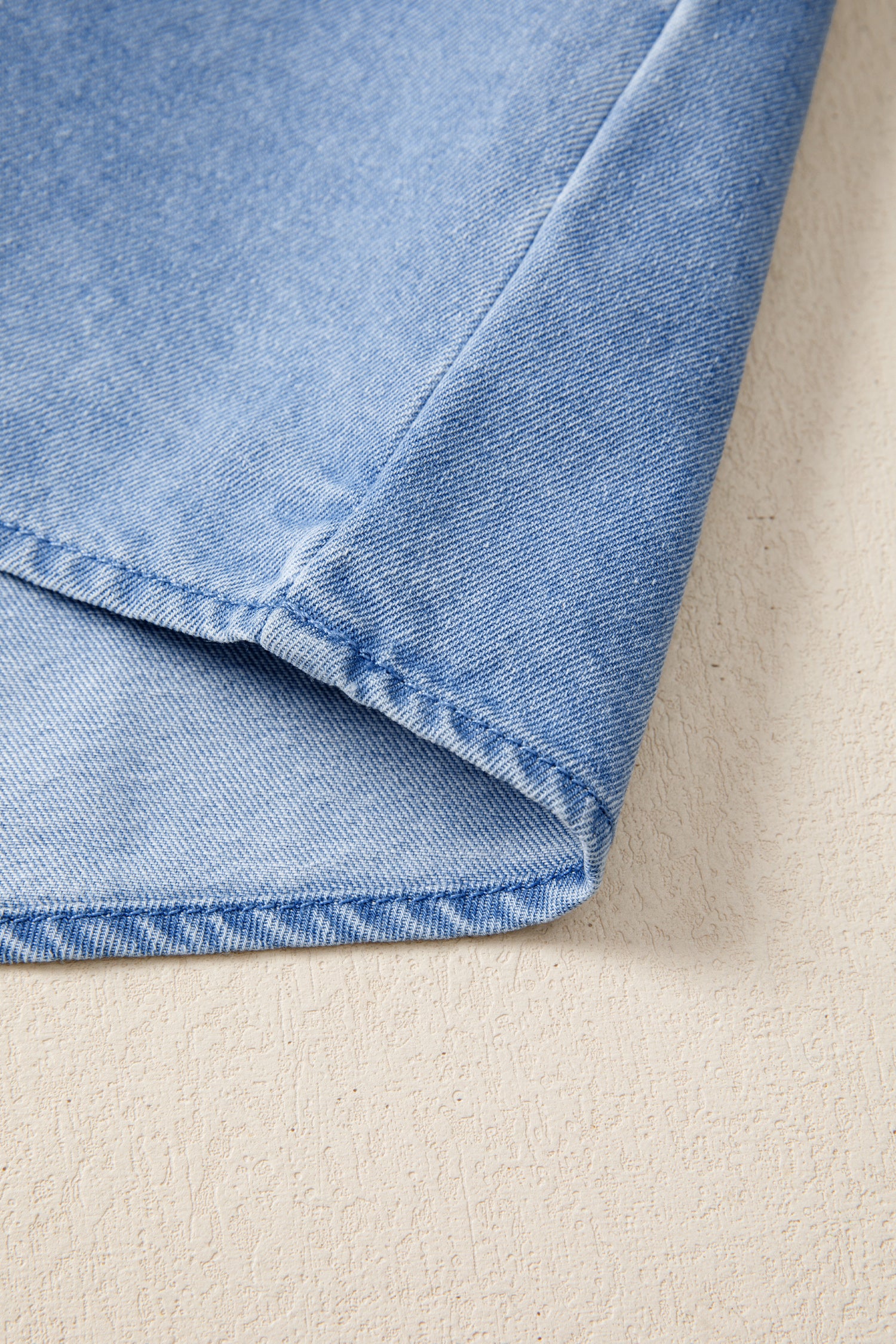 Women's distressed denim top with frilled collar and flutter sleeves, stylish casual blouse from Trendsi.