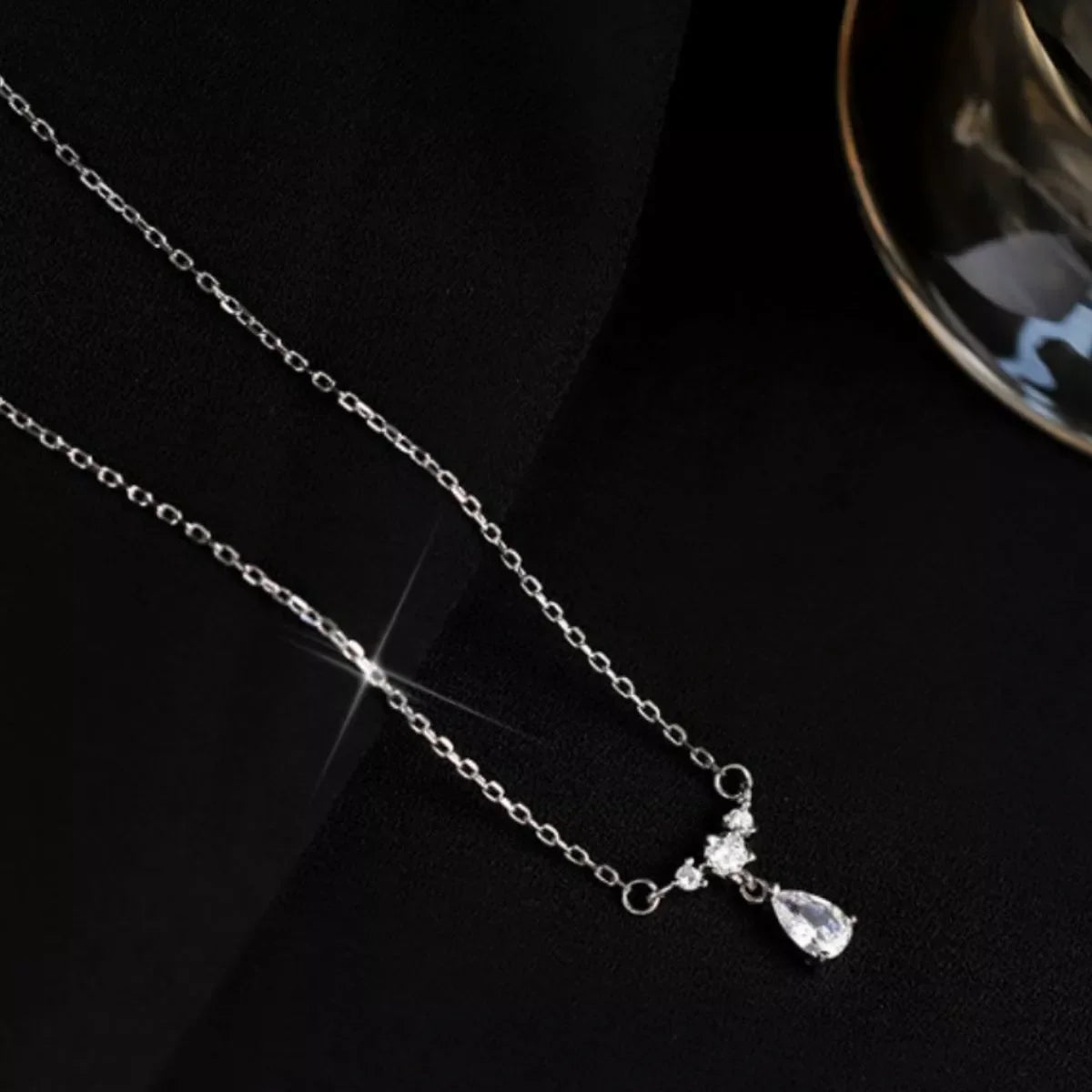 Sterling silver zircon teardrop necklace with elegant design, featuring a sparkling teardrop pendant on a delicate chain.