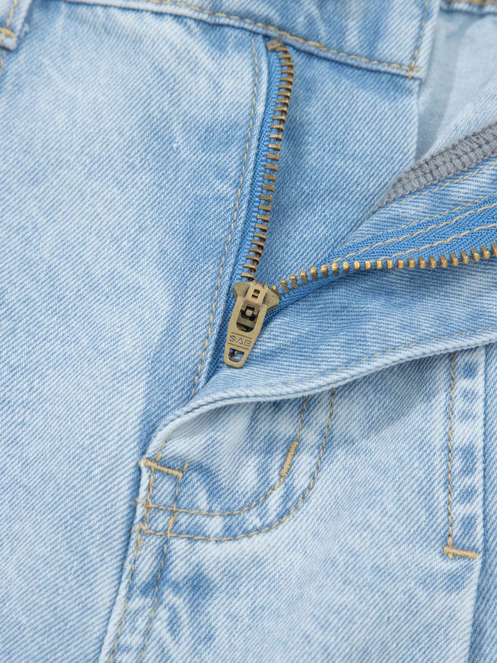 Trendsi studded wide-leg jeans with frayed hem and side slits, showcasing distressed denim and trendy design details.