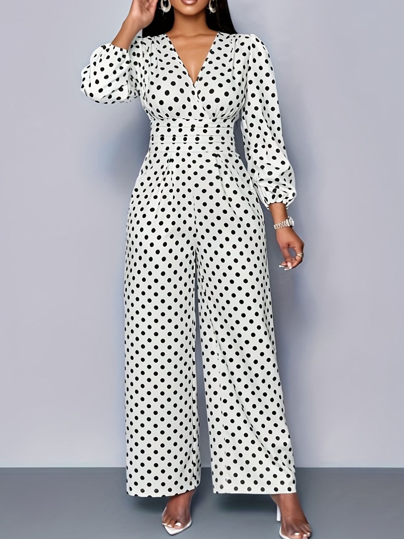 Women’s polka dot long sleeve wide leg jumpsuit with pockets by Plush Fashion Hub, featuring a stylish relaxed fit and casual elegance.