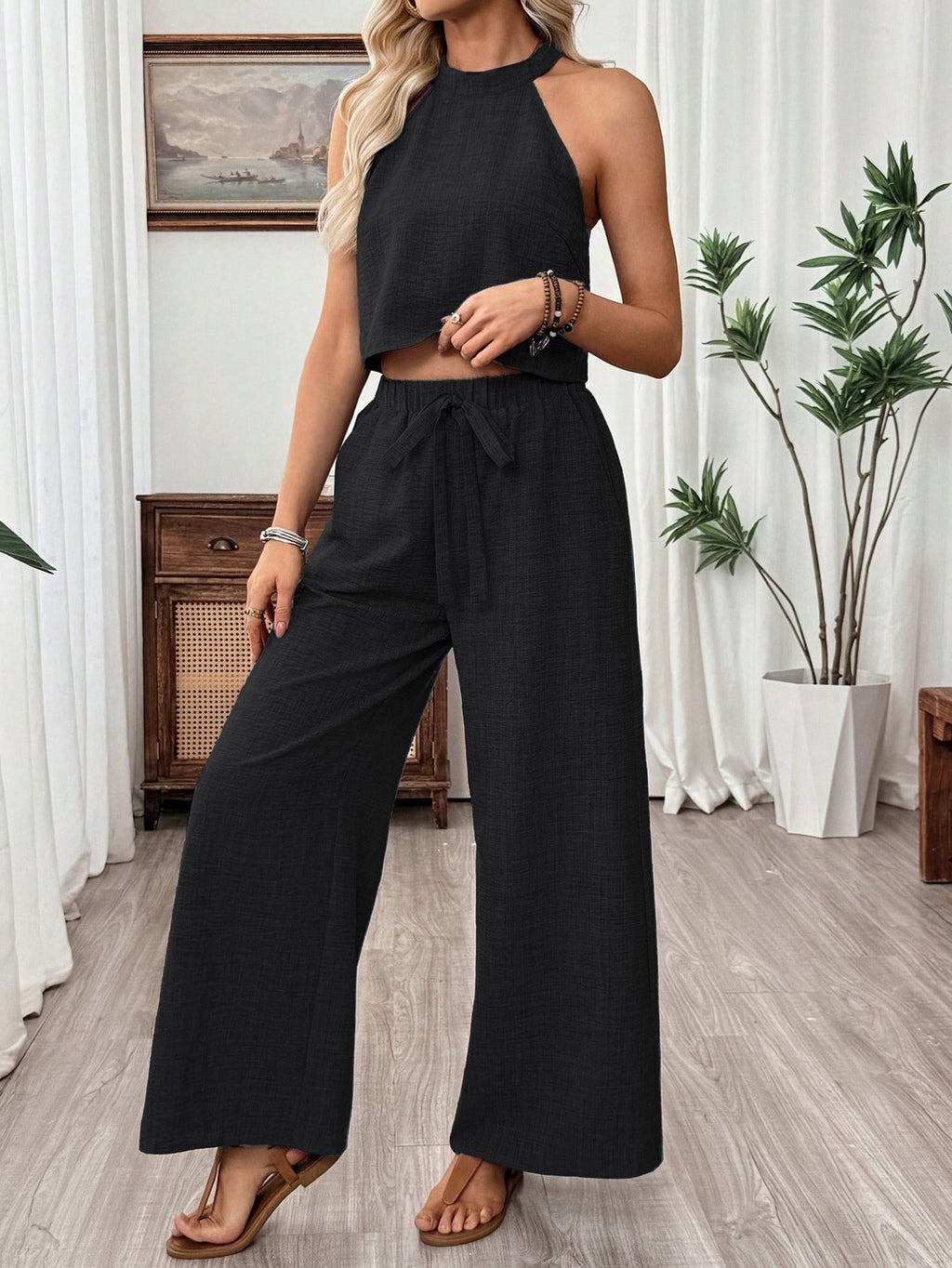 Women's halter neck cropped top and wide-leg pants casualwear set by FitiqueFit, featuring stylish matching two-piece outfit.