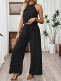 Women's halter neck cropped top and wide-leg pants casualwear set by FitiqueFit, featuring stylish matching two-piece outfit.