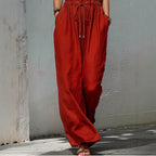 Women's sleeveless halter neck long jumpsuit in solid color, casualwear by Plush Fashion Hub, shown on a model.