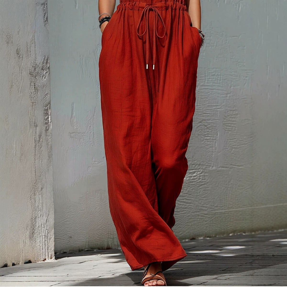 Women's sleeveless halter neck long jumpsuit in solid color, casualwear by Plush Fashion Hub, shown on a model.